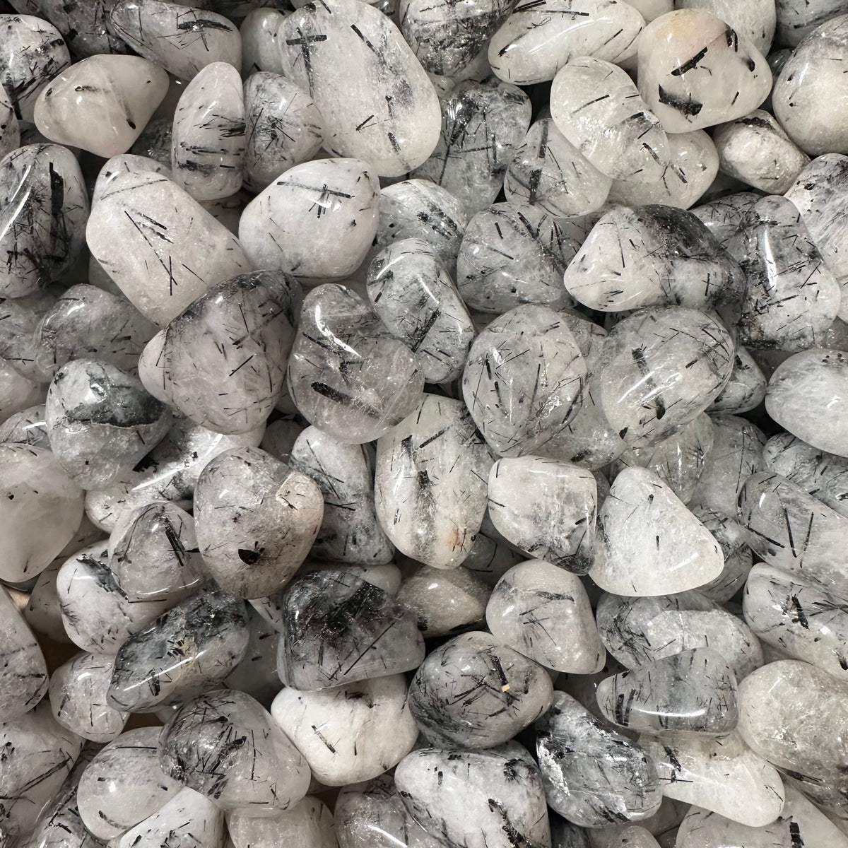 Polished tourmalinated quartz stone, clear to milky quartz threaded with jet-black tourmaline needles