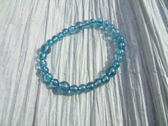 Aqua Aura Quartz crystal with iridescent blue metallic coating
