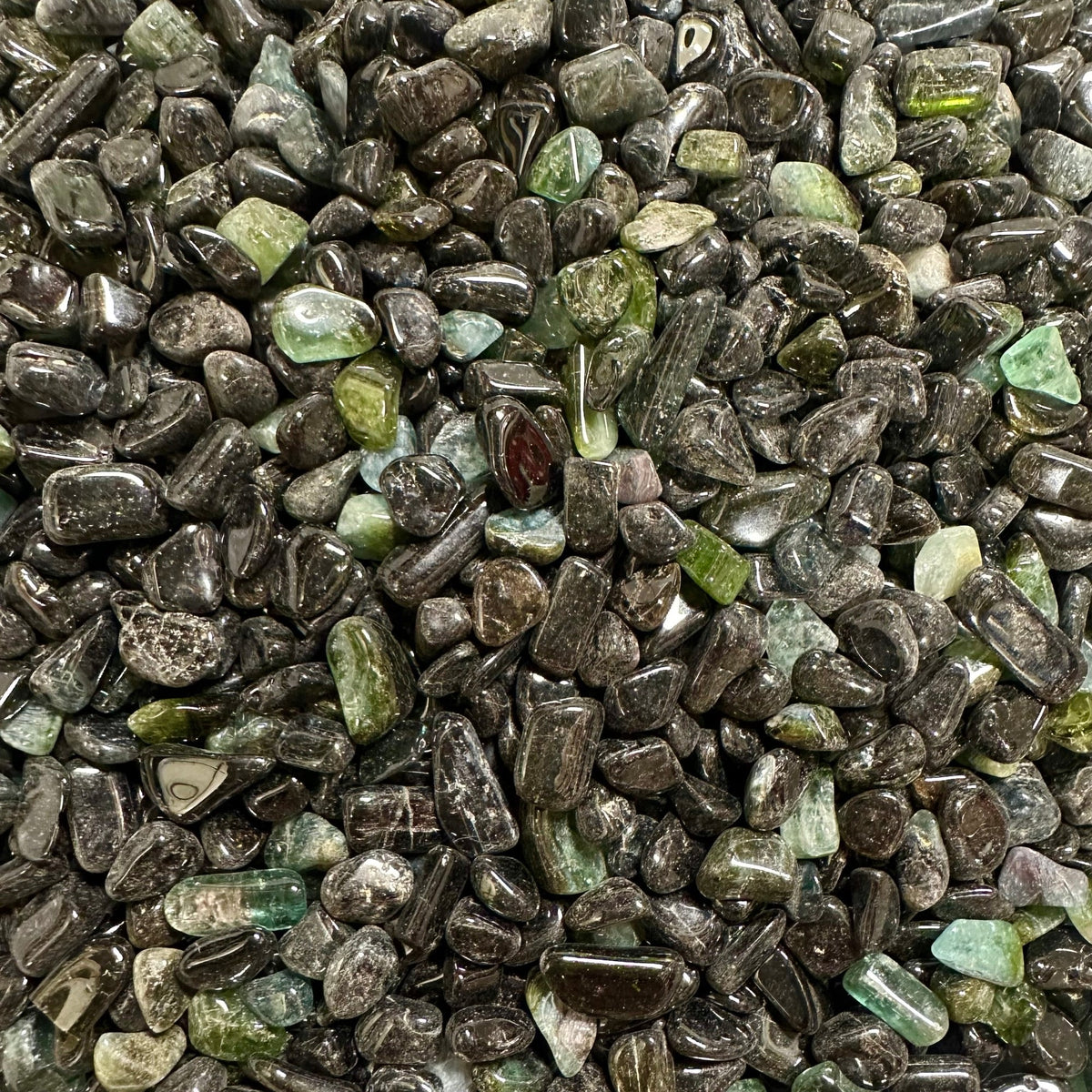 Raw green tourmaline crystal with long hexagonal striations and deep forest-green color