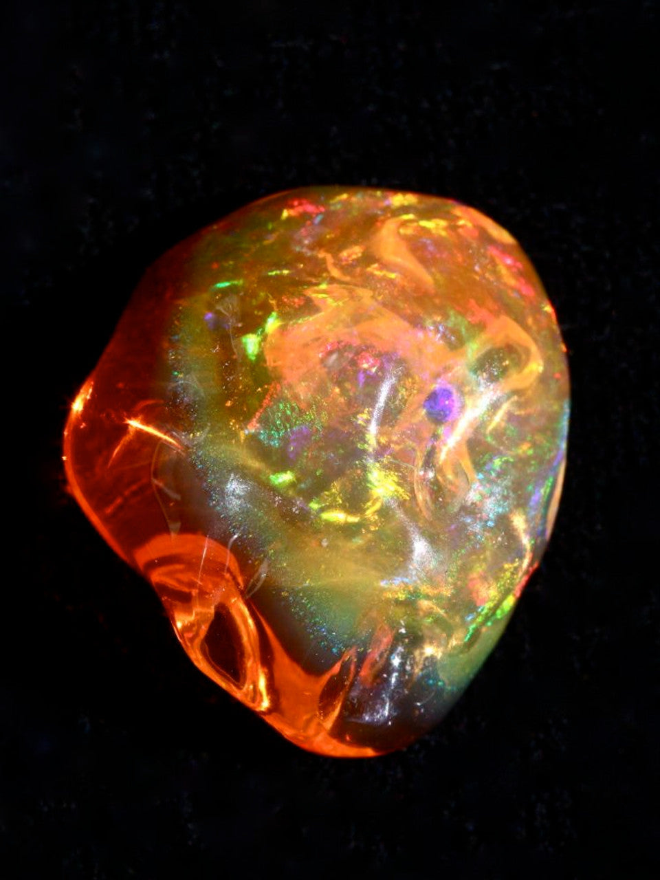 Glowing orange Mexican Fire Opal gemstone with fiery translucent color