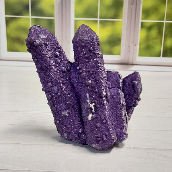 Natural purple fluorite crystals resting on pale quartz from Dongwuqi, Inner Mongolia, showing vivid violet tones against a light crystalline matrix