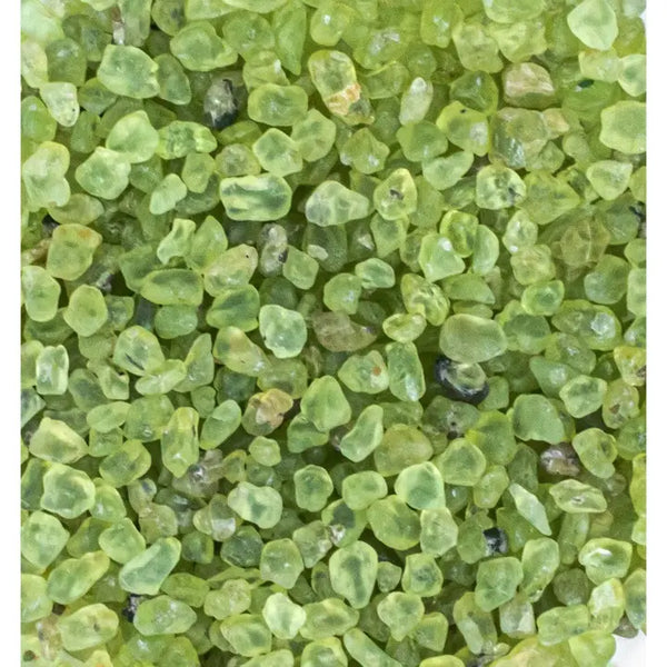 Bright green peridot gemstone with golden olive tones, polished and glowing with natural clarity