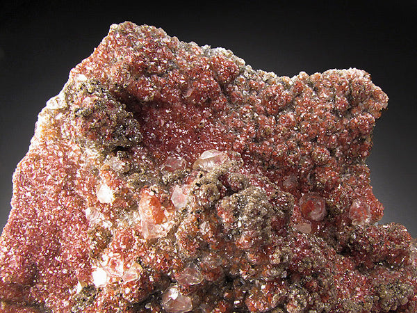 Rich red Red Velvet Calcite specimen with velvety texture, layered internal color, and natural calcite crystal structure shown in warm neutral light.