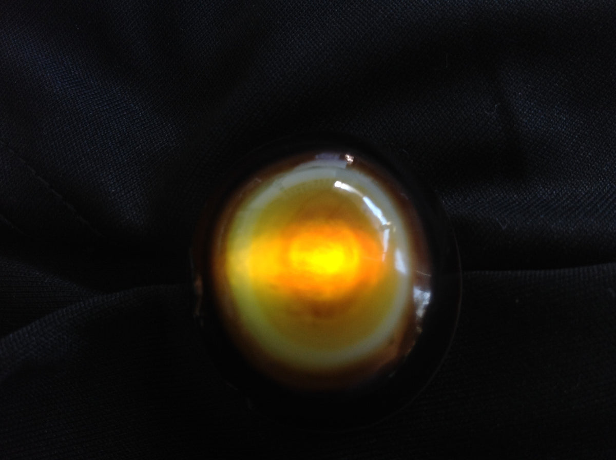 Banded red and white Sardonyx specimen shown backlit