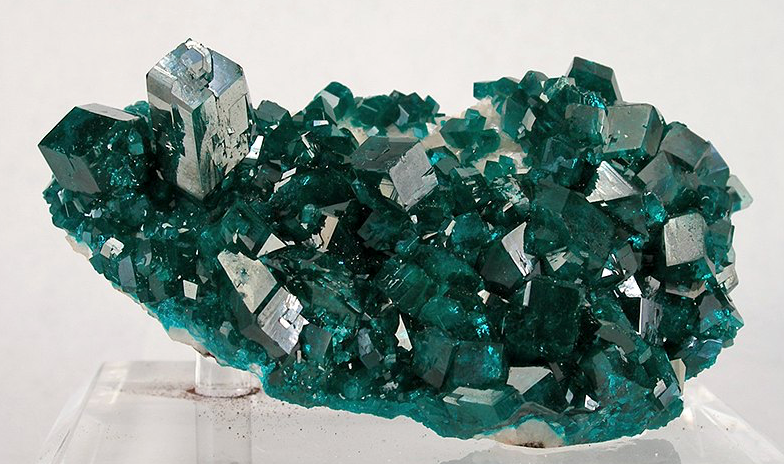 Dioptase crystal cluster from Congo showcasing vivid green translucent crystals.