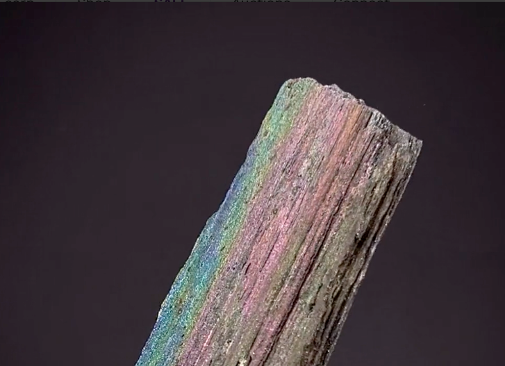 Natural iridescent hematite specimen from Andrade Mine in Brazil displaying rainbow surface coloration