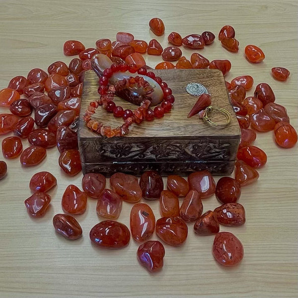 	•	Orange-red Carnelian gemstone glowing with vitality and grounding energy.