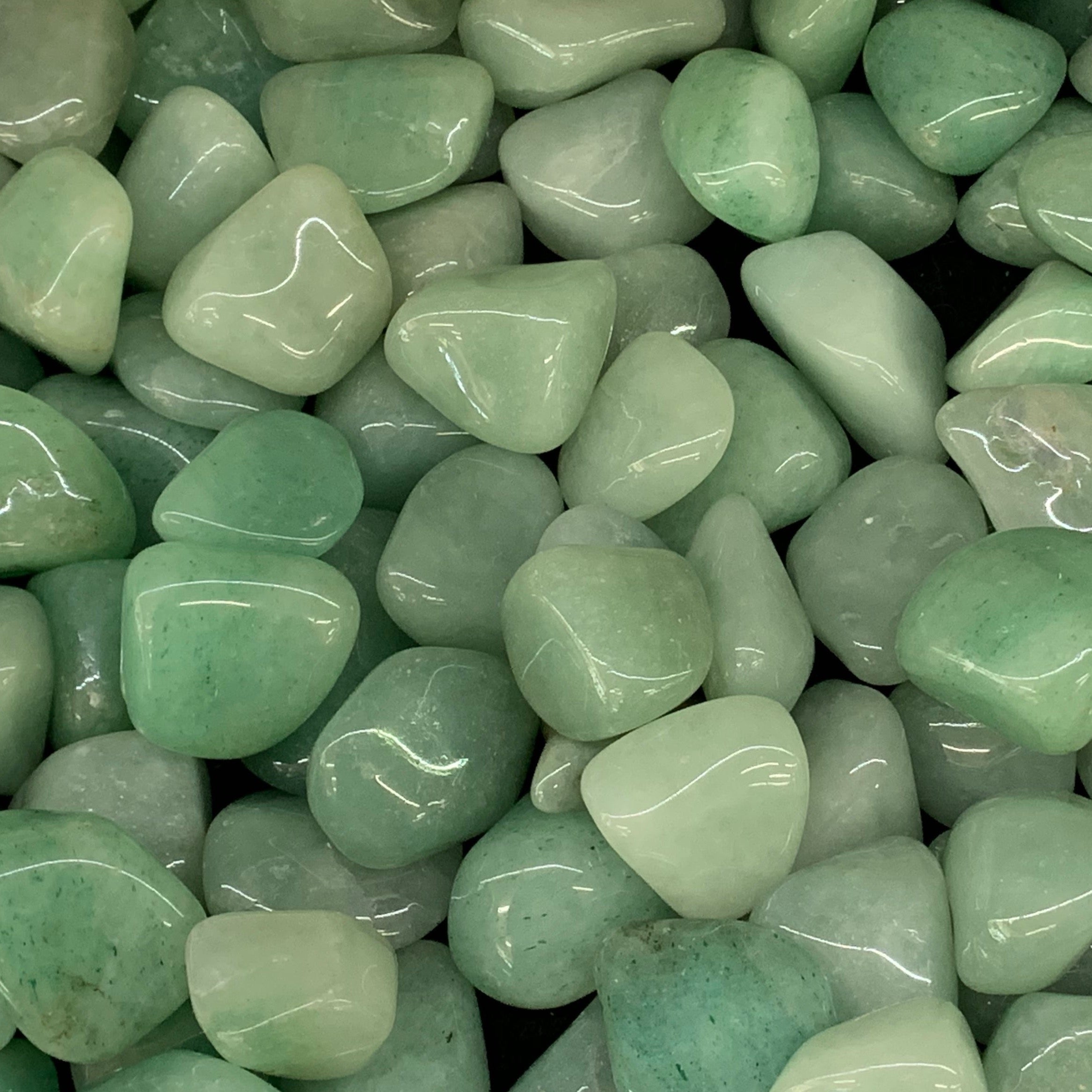 Polished Green Aventurine crystal with sparkling green shimmer and rounded edges.