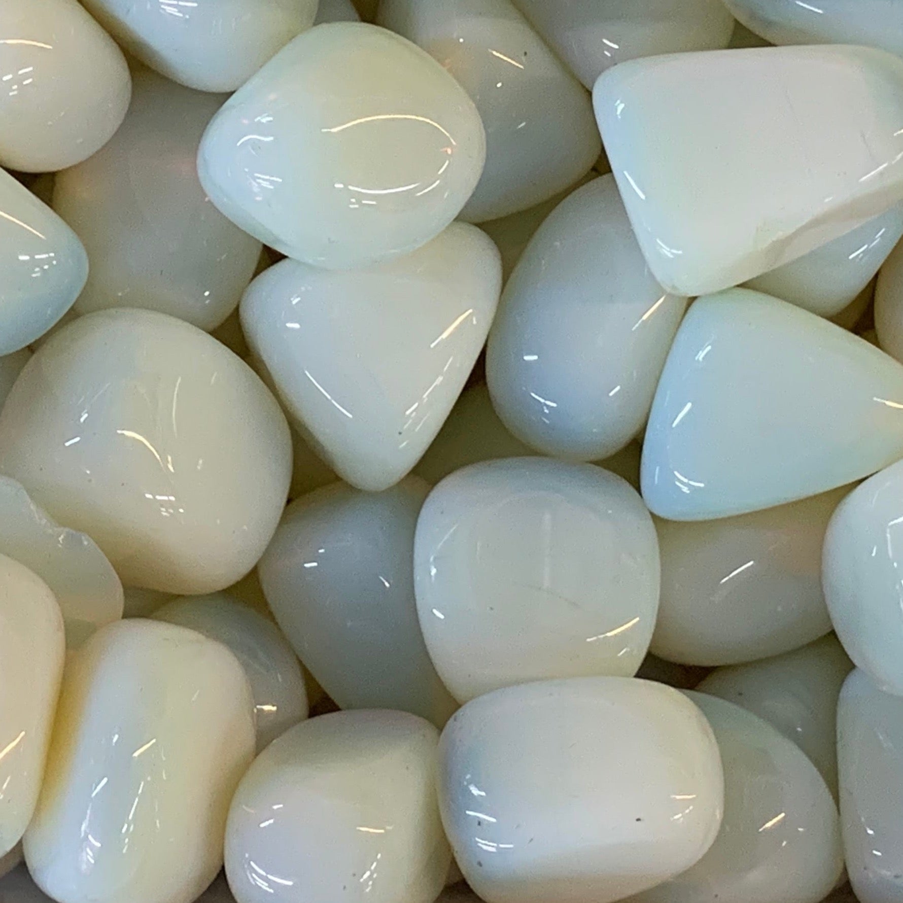 Iridescent opalite crystal glowing with soft blue and milky hues