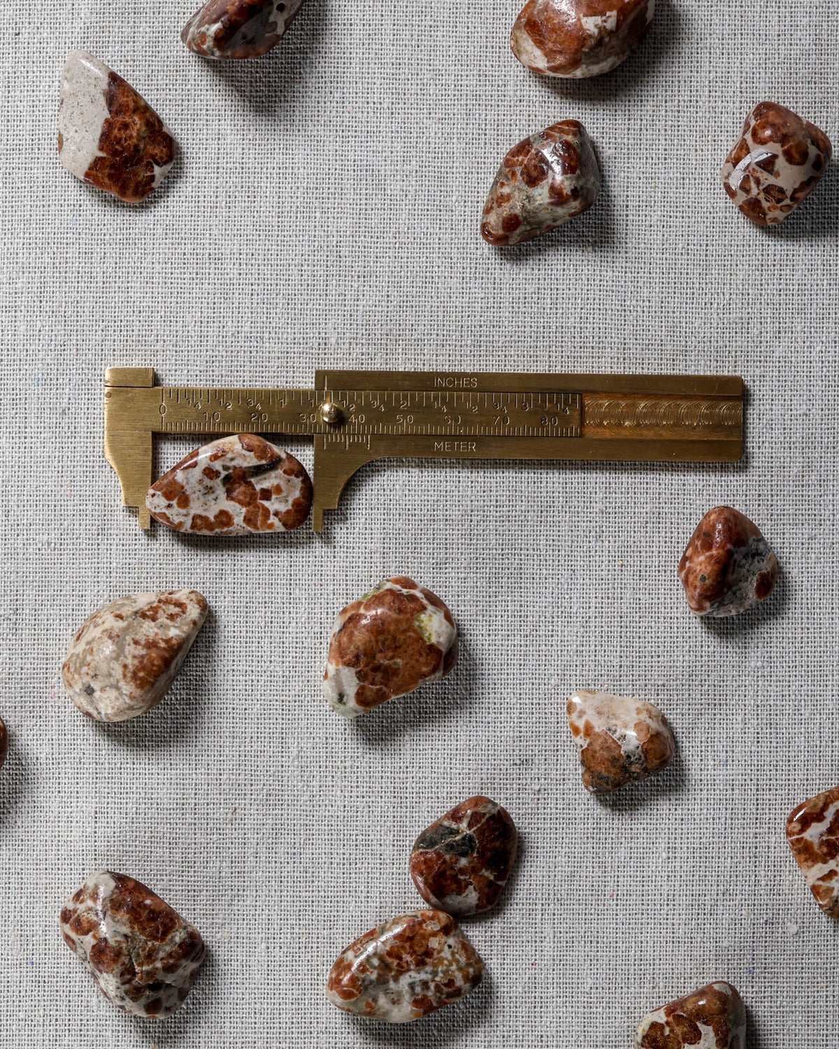 Garnet in Limestone Tumbled Gemstone – Sage Spirits, shown with ruler for size