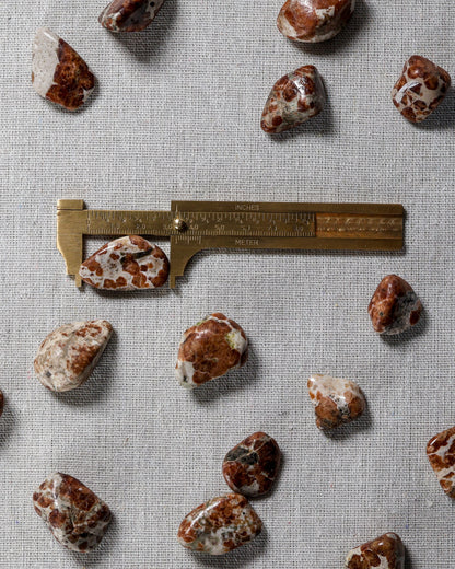 Garnet in Limestone Tumbled Gemstone – Sage Spirits, shown with ruler for size