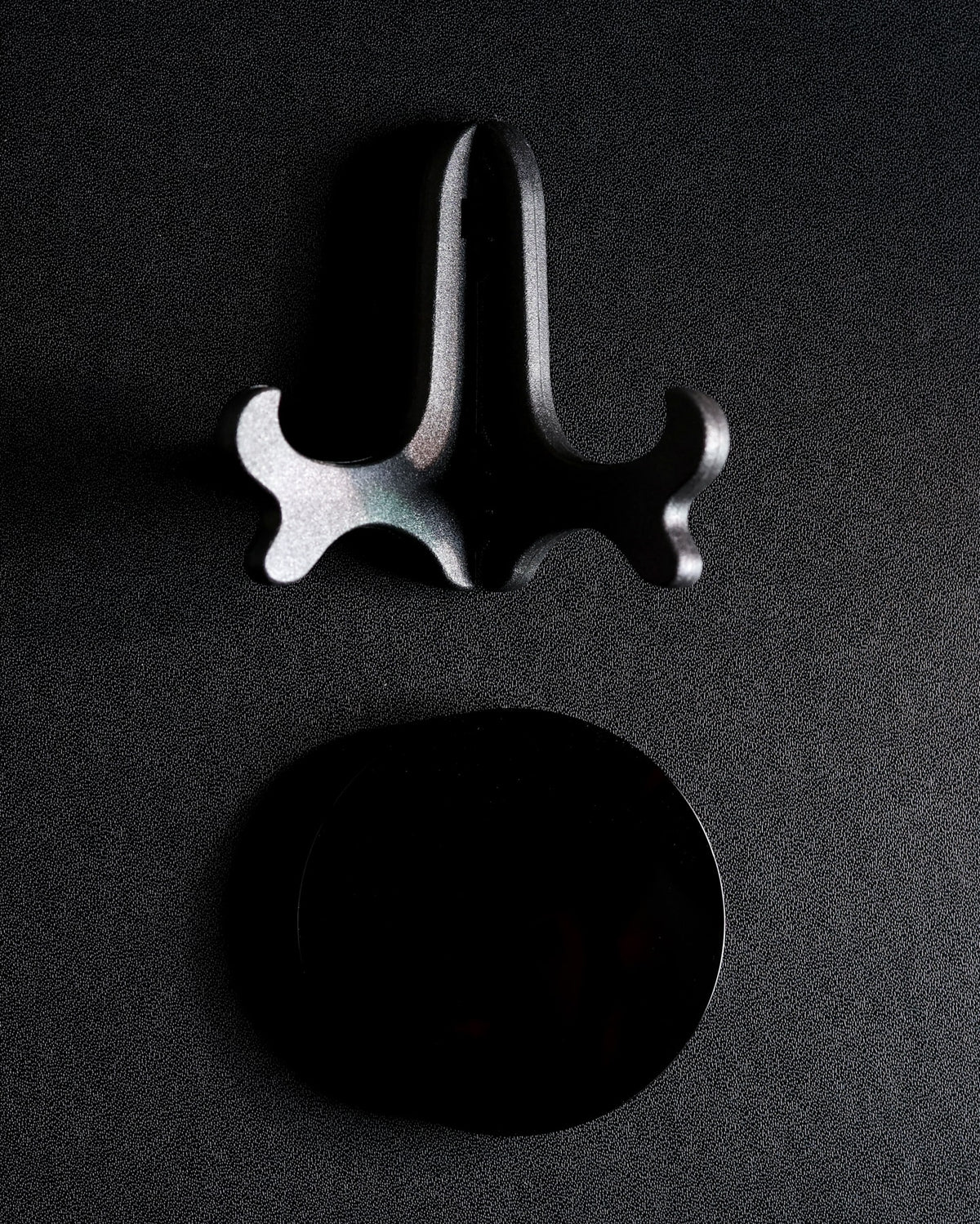 Obsidian scrying mirror shown beside its separate easel stand