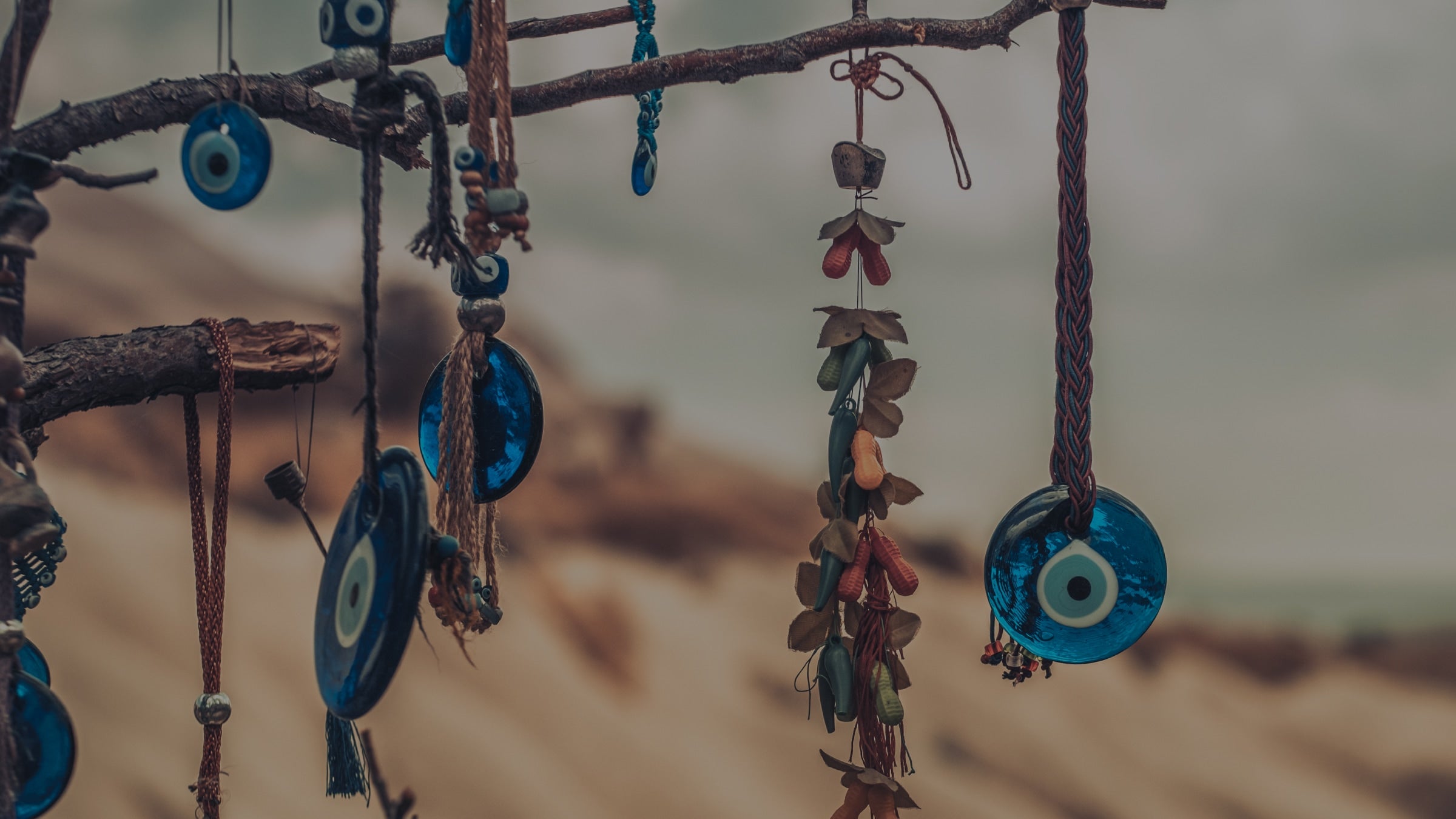 Decorative hanging items with blue and brown colors on a blurred natural background