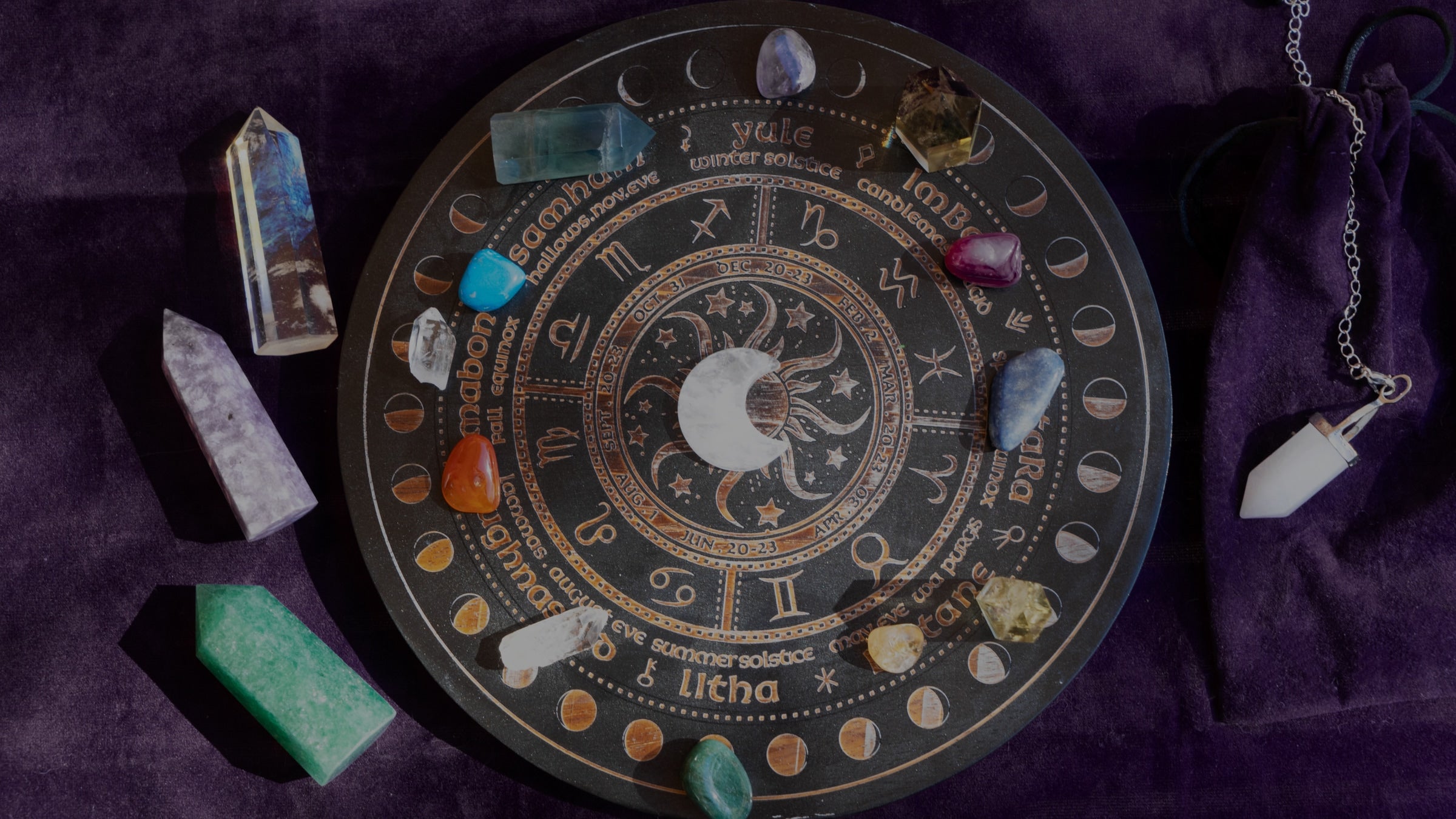 Astrological symbol on a dark background with crystals and stones