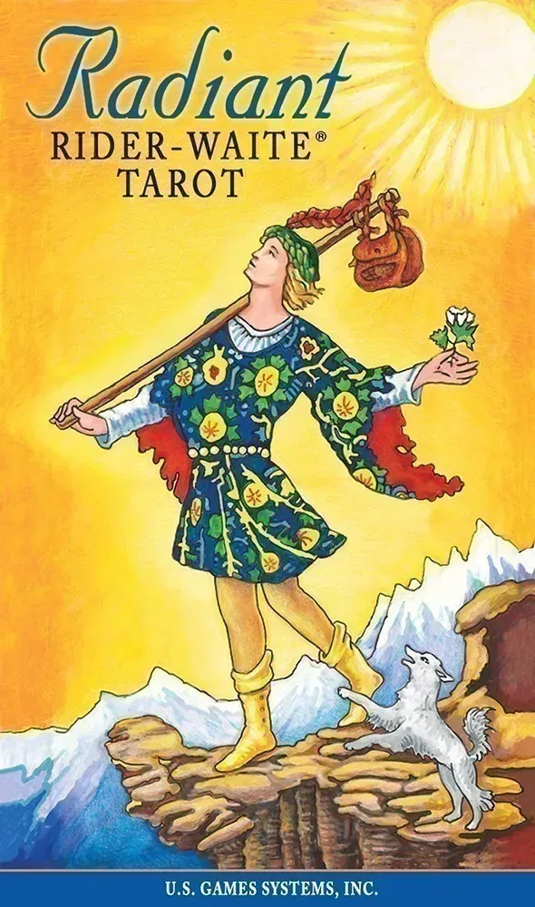 Radiant Rider-Waite Tarot box cover showing The Fool walking joyfully toward a cliff under a bright golden sun, carrying a small bundle on a staff, holding a white flower, with a small white dog at his feet and colorful patterned clothing against a glowing yellow sky.