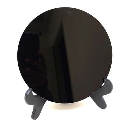 Close-up of the polished black obsidian scrying mirror on its stand