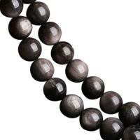 A bracelet made of black obsidian stones, with each stone approximately spherical in shape.