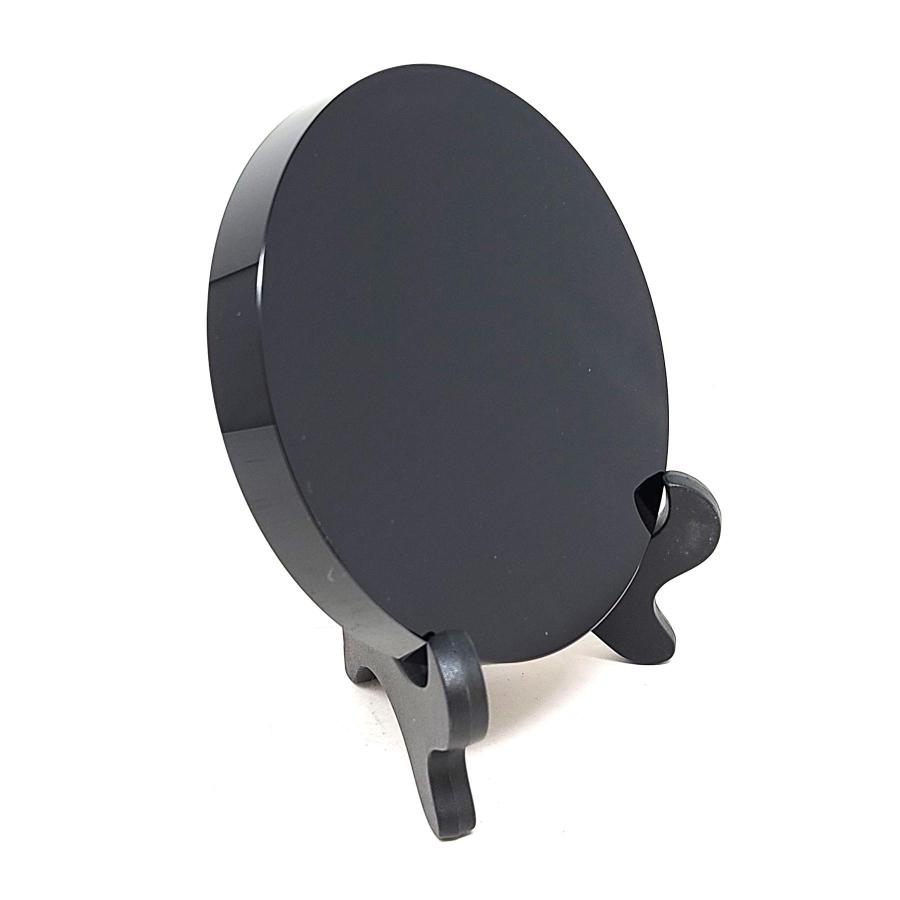 Obsidian scrying mirror and stand on a plain white background